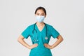 Covid-19, coronavirus disease, healthcare workers concept. Confident professional physician, doctor in medical mask and