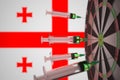 COVID-19 coronavirus disease vaccine syringes hit target near the Georgian flag. Successful research and vaccination in