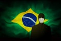 COVID-19 coronavirus epidemic in brazil. Silhouette man in medical mask on a background abstract Brazilian flag. Global COVID-19