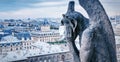 COVID-19 coronavirus in France, medical mask on gargoyle of Notre Dame in Paris. Tourist landmarks closed due to corona virus Royalty Free Stock Photo