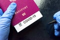 COVID-19 coronavirus pandemic and travel concept, COVID-19 note in passport. Novel corona virus outbreak, spread of epidemic from Royalty Free Stock Photo