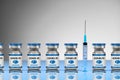 Covid-19 Coronavirus Vaccine blue vials in a row with a syringe Royalty Free Stock Photo