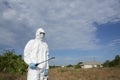 Covid-19 Coronavirus virus. A man in protective clothing in a white overalls disinfects and decontaminates in public places Royalty Free Stock Photo
