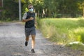 Covid-19 deconfinement - young attractive and happy man outdoors in city park doing running workout wearing protective face mask Royalty Free Stock Photo