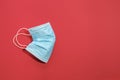 COVID-19 disposable surgical face mask on red background