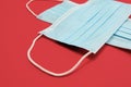 COVID-19 disposable surgical face masks on red background