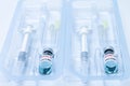 Covid-19, flu, coronavirus liquid vaccine vial bottle and syringe set in plastic package container preparing for injection Royalty Free Stock Photo