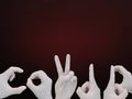 COVID by hand gestures which wearing white gloves isolated on red and black gradient background Royalty Free Stock Photo