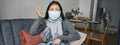 Covid-19 and health concept. Young asian woman in medical face mask, feels sick and unwell, catching flu, protecting