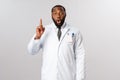 Covid19, healthcare and clinic concept. African american male doctor, physician have great idea, raise finger up eureka