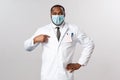 Covid19, healthcare and clinic concept. Portrait of confident handsome african-american doctor, pointing himself and