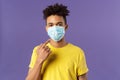 Covid19, healthcare and medicine concept. Young hispanic guy with afro haircut, wear and point at face mask, social