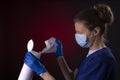 COVID-19 healthcare worker using PPE protective equipment and disinfectant wipes Royalty Free Stock Photo