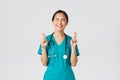 Covid-19, healthcare workers, pandemic concept. Optimistic happy and hopeful asian female nurse, intern waiting for