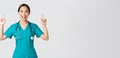 Covid-19, healthcare workers, pandemic concept. Smiling cheerful pretty nurse, female doctor or intern in scrubs Royalty Free Stock Photo