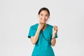 Covid-19, healthcare workers and preventing virus concept. Smiling cute asian doctor, female nurse examine patient lungs Royalty Free Stock Photo