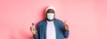Covid-19, lifestyle and lockdown concept. Handsome african-american hipster man in face mask and beanie, showing hand Royalty Free Stock Photo