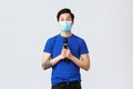 Covid019 lifestyle, people emotions and leisure on quarantine concept. Cute young asian man in medical mask want sing Royalty Free Stock Photo