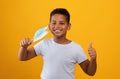 Cheerful black boy taking off face mask Royalty Free Stock Photo