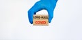 COVID-19 long-haul covid symptoms symbol. Wooden blocks with words long-haul covid. Doctor hand, blue glove, beautiful blue Royalty Free Stock Photo