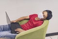 Covid-19, Man wearing face mask sleeping on sofa with laptop computer, Wearing a face mask to protect against coronavirus, busines Royalty Free Stock Photo