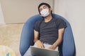 Covid-19, Man wearing face mask sleeping on sofa with laptop computer, Wearing a face mask to protect against coronavirus, busines Royalty Free Stock Photo