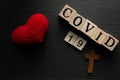 COVID-19 name of Corona virus from Wuhan text word on drak wood background with heart love