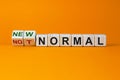 Covid-19 new normal symbol. Turned cubes and changed the words `not normal` to `new normal`. Covid-19 postpandemic new normal Royalty Free Stock Photo