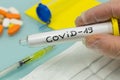 COVID-19 / Coronavirus official name. Vial with virus in his hand in laboratory glove