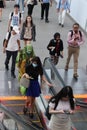 Covid-19 outbreak in Asia people wearing face masks in busy train station escalator Malaysia KL Sentral Kuala Lumpur Station mall