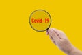 Covid-19 is outbreak while search people with infection with magnifying glass, text covid-19