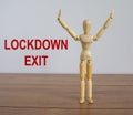 COVID-19 Pandemic Coronavirus and business concept. Wooden model of a man. Inscription `lockdown exit