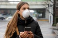 COVID-19 Pandemic Coronavirus Young Woman using Mobile Application Wearing Face Mask on Smart Phone App in City Street