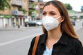 COVID-19 Pandemic Coronavirus Woman in city street wearing KN95 FFP2 mask protective for spreading of disease virus SARS-CoV-2.