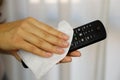 COVID-19 Pandemic Coronavirus Woman Cleaning with Wet Wipes TV Remote Control Disinfect Against Coronavirus Disease 2019 Outbreak