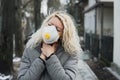 COVID-19 Pandemic Coronavirus Young girl in city street wearing face mask protective for spreading of Coronavirus