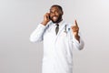 Covid19, pandemic and online medicine concept. Professional handsome african-american doctor consult patient on phone Royalty Free Stock Photo