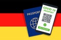Covid-19 Passport on Germany Flag Background. Vaccinated. QR Code. Smartphone. Immune Health Cerificate. Vaccination Document.