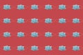 COVID-19 pattern of surgical face masks on red background