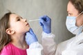 COVID-19 PCR test and kid, nurse holds swab for nasal sample from adorable child