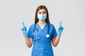 Covid-19, preventing virus, health, healthcare workers and quarantine concept. Curious female doctor or nurse in blue Royalty Free Stock Photo