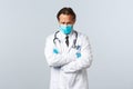 Covid-19, preventing virus, healthcare workers and vaccination concept. Offended timid doctor in medical mask and gloves