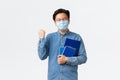Covid-19, preventing virus, and social distancing at university concept. Rejoicing satisfied asian student passed exams