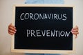 Covid prevention. Coronavirus concept. Boy hold inscription on the board