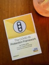 The Covid-19 protection framework Flyer with salt lamp on wooden background, vertical.