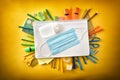 Covid-19 protection on notebook and tools around yellow top view Royalty Free Stock Photo
