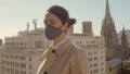 Covid protection. Young brown hair lady wearing a grey face mask. Close-up shot side view portrait high-resolution image