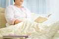 Covid-19 quarantine activity for senior woman read a book stay home to avoid risk Royalty Free Stock Photo