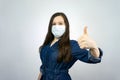 Covid19, quarantine. Happy girl show thumbs up in medical face mask. stay safe during coronavirus outbreak