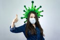 Covid19, quarantine. Happy woman show thumbs up in medical face mask. stay safe during coronavirus outbreak